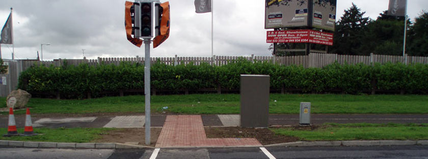 Tactile paving at traffic light.